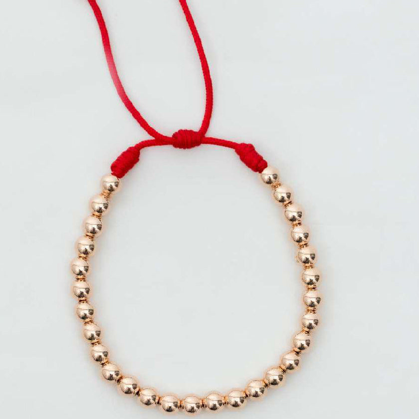 Pulsera tejida oro laminado rosa con balín #4